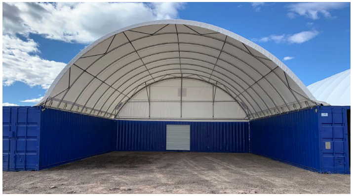 an image of a canopy extended between and over two shipping containers